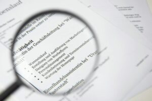 Close-up of a business document text under a magnifying glass.